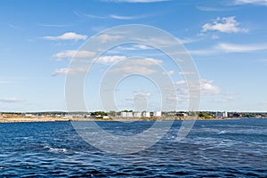 White Oil Tanks Between Blue Sky and Sea