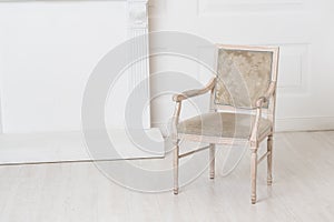 White old-fashioned retro style chair standing in an empty room