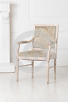 White old-fashioned retro style chair standing in an empty room