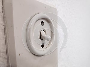 White old light switch on white wall