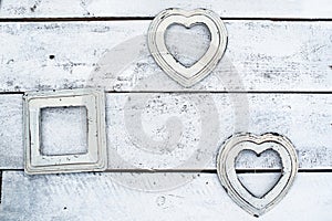 white old photo frames on a wooden background. in the shape of a heart. wall, interior