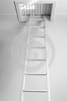 White old staircase to a closed wooden attic