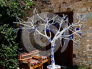 The white old tree decorated with the eye-shaped amulets - Nazar boncuk, Side photo