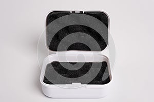 White open box lined with black sponge inside, isolated on a white background