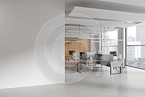 White open space office corner with blank wall