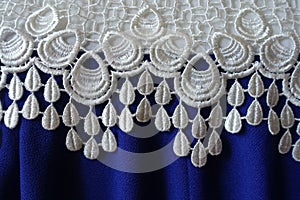 White openwork lace and folded blue fabric
