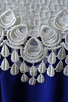 White openwork lace and rippled blue fabric