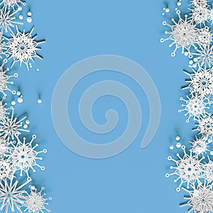 White openwork volumetric snowflakes on a light blue background. Beautiful Christmas 3D greeting card