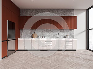 White and orange kitchen interior with fridge