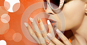 White orange manicure and makeup .