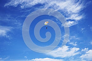 White-orange parachute canopy of tandem is flying against the ba