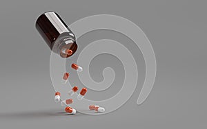 White-orange pills falling from a bottle on a gray background.