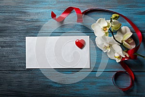 White Orchid on blue wooden background