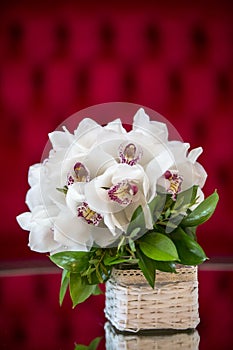 White orchid bouquet in a basket