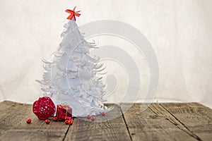 White origami Christmas tree with red decoration