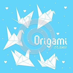 White origami cranes on blue background