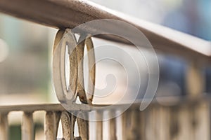 white ornamental cast iron forged railing background focus Close up