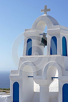 White orthodox church bell tower. Oia, Santorini Greece. Copyspace