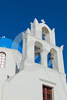 White orthodox church bell tower. Oia, Santorini Greece. Copyspace