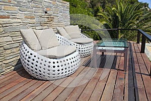 White outdoor furniture on wood resort terrace