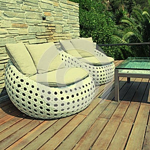 White outdoor furniture on wood resort terrace