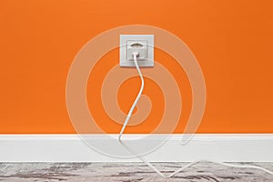 White outlet on orange wall