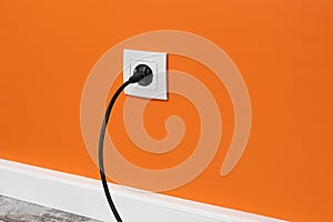 White outlet on orange wall