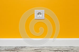 White outlet on yellow wall