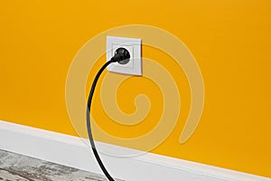 White outlet on yellow wall