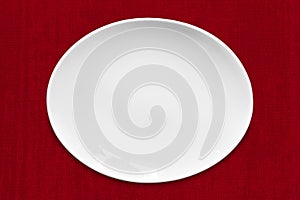 White Oval Plate on Red Fabric