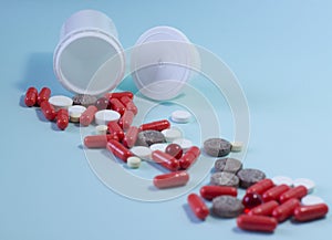 white package a handful of tablets, capsules colored on a blue background. space for text