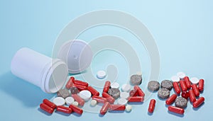 white package a handful of tablets, capsules colored on a blue background. space for text