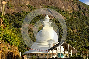White pagoda at the foosteps of the Adam's Peak, tallest mountain in Sri Lanka