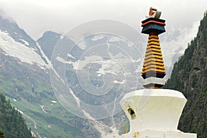 White Pagoda in front of snow mountains