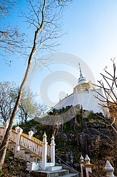 White pagoda with stair walkway at Tham Phra Sabai temple