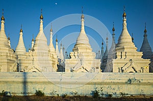 White pagodas of Sanda Muni Paya Buddhist stupa in Mandalay, Myanmar