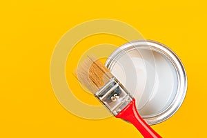 White Paint Can with Brush Top View On Yellow Background. - Image