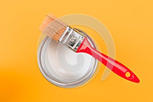 White Paint Can with Brush Top View On Yellow Background. - Image