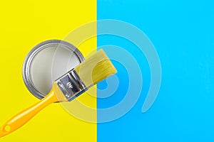 White Paint Can with Brush Top View On Yellow and blue  Background.- Image