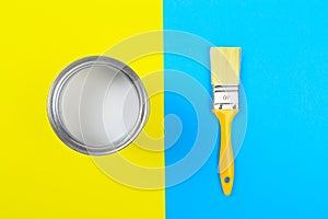 White Paint Can with Brush Top View On Yellow and blue  Background.- Image