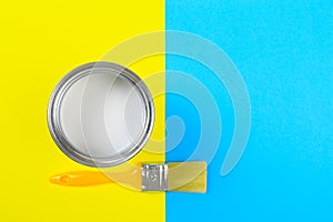 White Paint Can with Brush Top View On Yellow and blue  Background.- Image