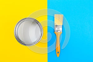 White Paint Can with Brush Top View On Yellow and blue  Background.- Image