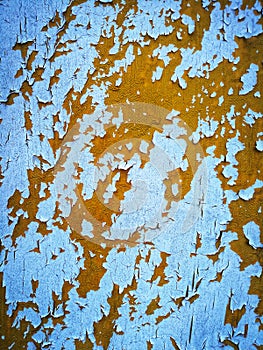 White paint peeling off on orange surface