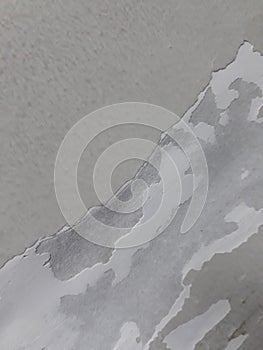 white paint peeling off the wall