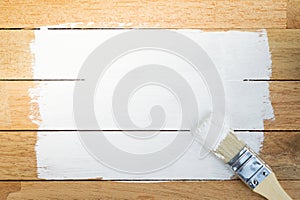 White paint space with paintbrush on wood background