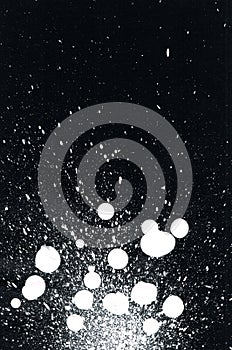 White paint splatter on black background