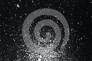 White paint splatter on black background