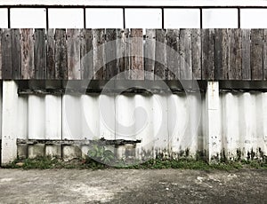 White painted cement and wooden board fence texture pattern on house wall surface background. Detail backdrop, abstract design, in