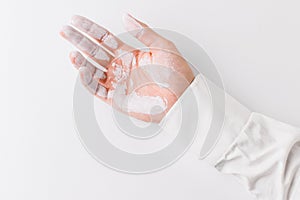 White painted hand over white background.