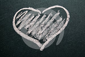 White painted heart on a black background